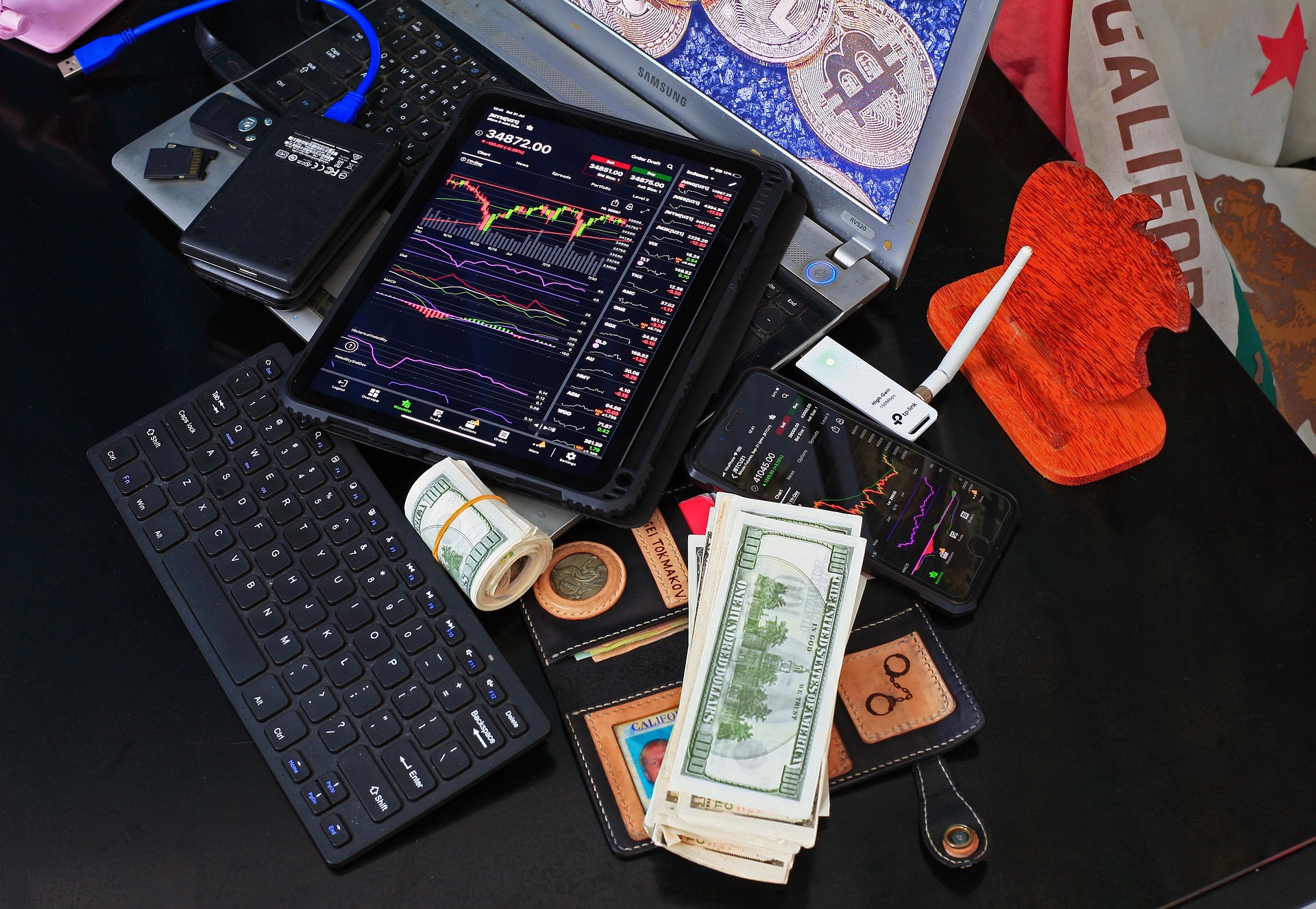 A trading desk with charts, hardware wallets and cash, representing hands-on market research